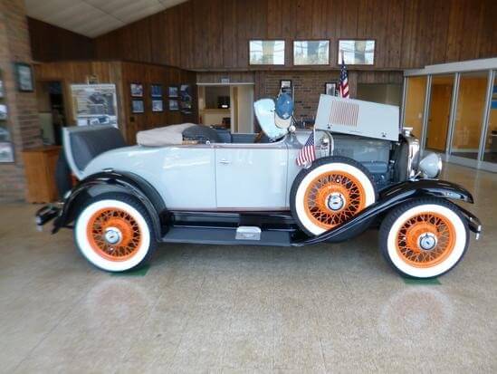 Vintage white convertible with orange wheel spokes
