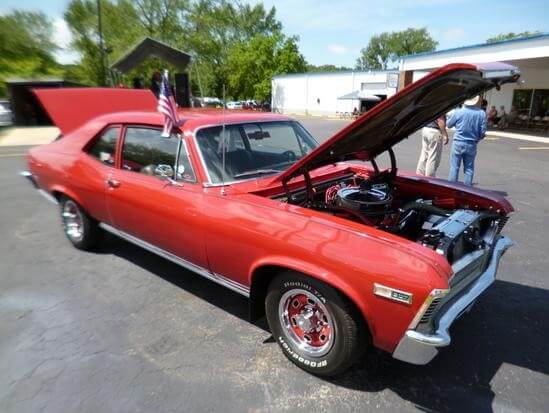 Red muscle car with hood open